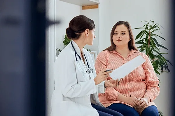 Doctor discussing health with patient in office.