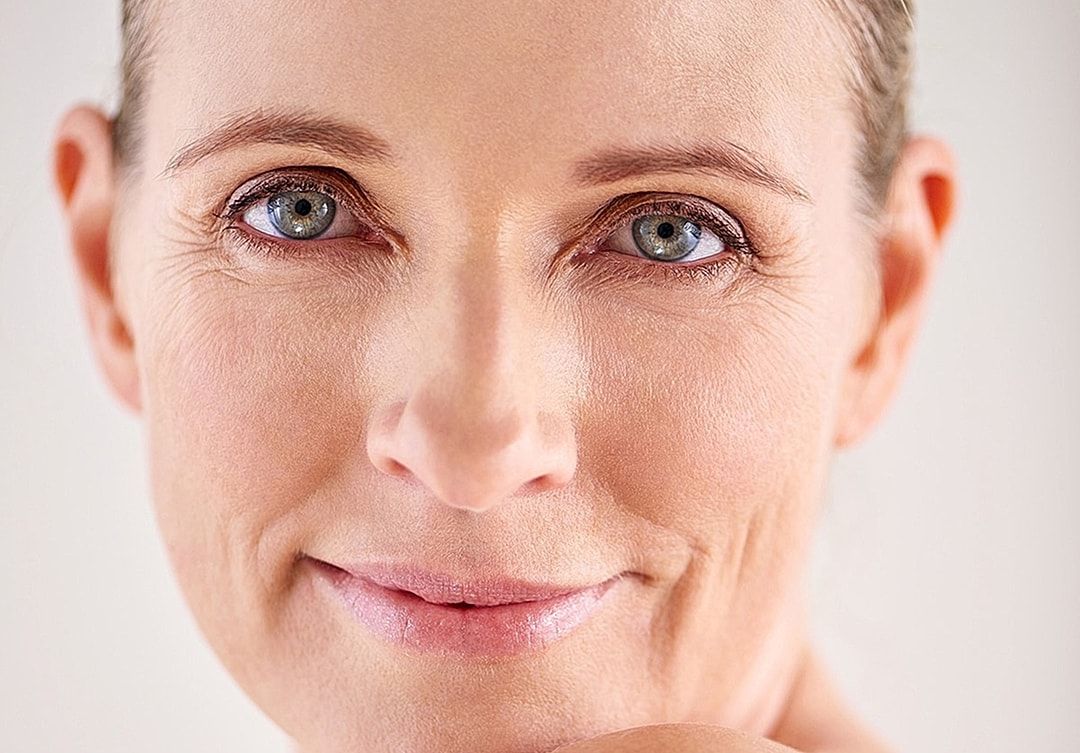 Smiling woman with natural makeup and soft lighting