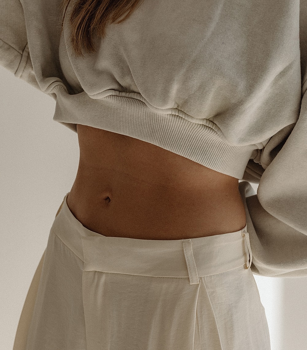 Woman in black leggings outdoors, focused on legs.