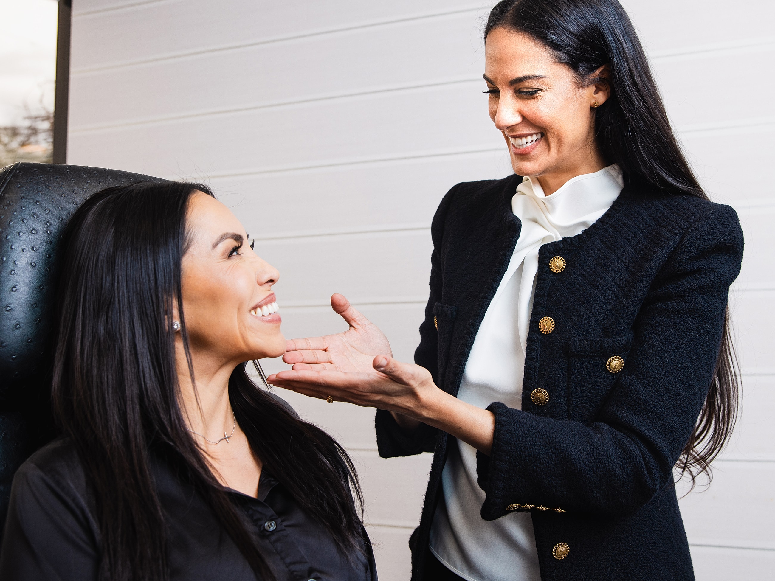 Smiling woman touching her hair indoors.