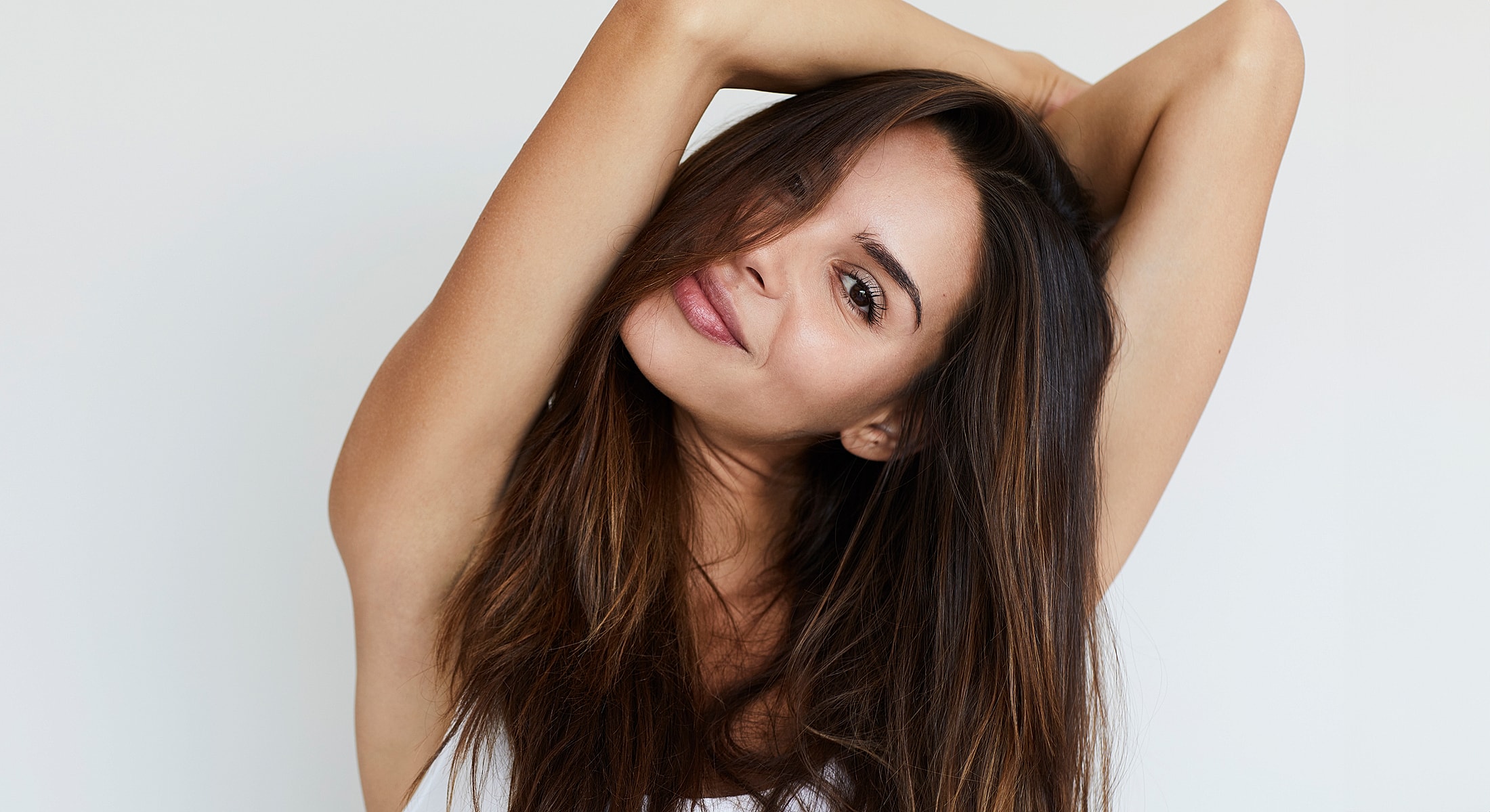 Woman posing playfully with long, flowing hair.