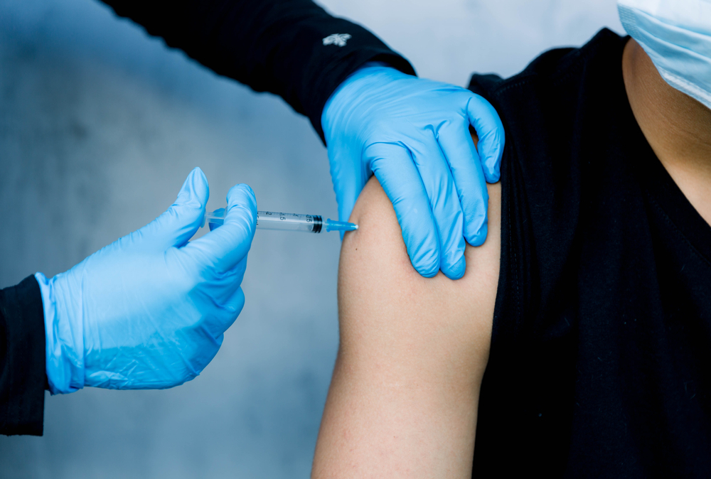 male patient getting intramuscular injection in arm
